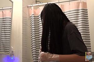Beautiful Woman Dyes Hair Black in Mirror