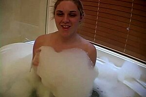 Barbi reveals her big tits in a bubbly bathtub.