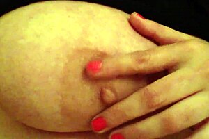 An employee plays with her huge tits at the office desk