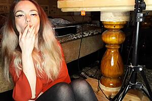 Does the wife smoke a cigarette?