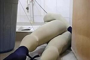 zentai slave bound in penis toilet bondage