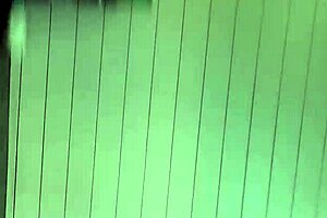 Black gay guy at public urinal stroking cock while spying.