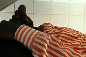 Black gay guy at public urinal stroking cock while spying.