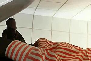 Black gay guy at public urinal stroking cock while spying.