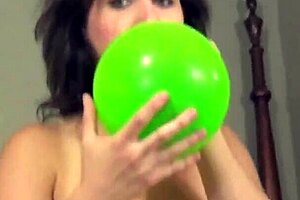 Brunette looner humps balloons while masturbating topless
