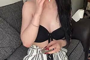 An old pretty teen smokes early in the morning while clothed.