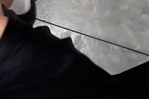 A woman flashes at the laundry mat, surprising a mature lady who looks intrigued.