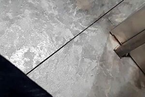 A woman flashes at the laundry mat, surprising a mature lady who looks intrigued.