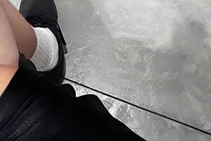 A woman flashes at the laundry mat, surprising a mature lady who looks intrigued.