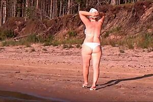 Juicy milf with a big ass in a white bikini