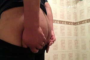 Cross gay trying on leggings in a provocative way