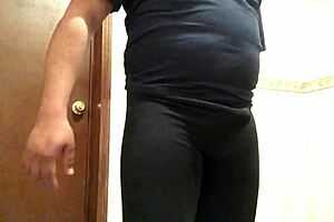 Cross gay trying on leggings in a provocative way