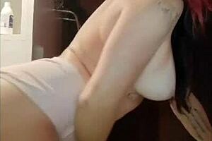 tattooed redhead shows tan lines on big tits and ass