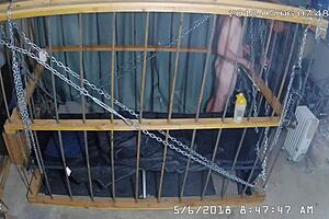 Intense cage bondage for gay slave, bound tightly in the cage