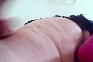 the girl in lingerie plays with dildos on her ass