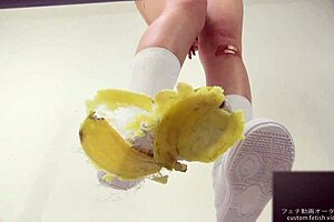 The girl says, 'watch me crush this banana with my feet.'