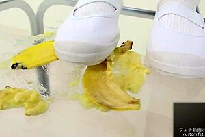 The girl says, 'watch me crush this banana with my feet.'