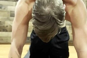 Bodybuilder stretches in a sexy muscular routine