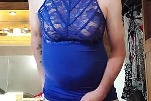 Shemale in blue dress teases cock with big tits.