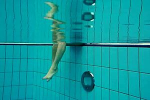 petite russian babe deniska swimming underwater in the pool