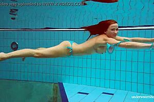 petite russian babe deniska swimming underwater in the pool