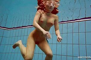 petite russian babe deniska swimming underwater in the pool