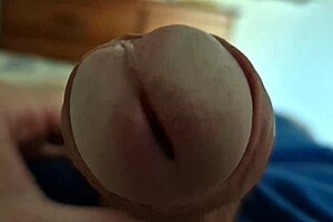 Detailed close-up of a young twink's dick head in solo play.