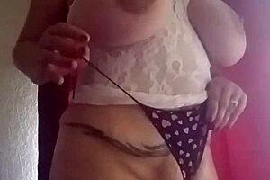 She licks her big tits while playing with herself in a solo session