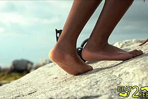 giggles feet love rubbing giant hot rock at beach