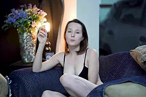 Sexy brunette smokes while wearing black lingerie