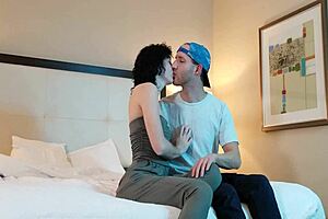 guy making out with hot woman in intimate setting