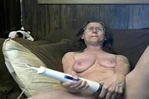 Pretty granny in pink lingerie performs on webcam.