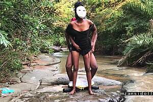 Ebony babe gets wild outdoors, teasing with a steamy strip in nature.