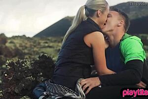 Photographer shoots petite model outdoors in nature.