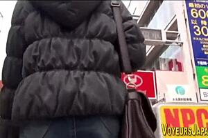 Asian babe in pantyhose flashes her panties during outdoor upskirt chase