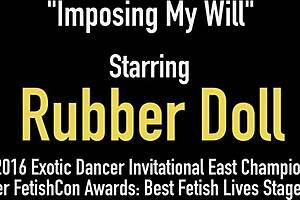 Latex rubberdoll in bikini imposes her will on slaves