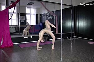 russian gymnast stretches naked on sofa softly