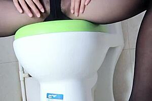 Big-Breasted Woman Masturbates In Toilet With Vibrator