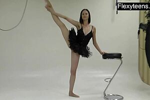 Athletic brunette gymnast stretches naked in workout