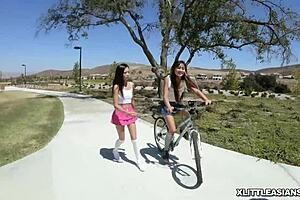 Two Asian cuties share a white cock orally