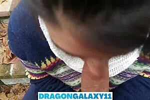 In the public park, the brunette amateur flashes her natural tits before giving a pov oral blowjob near neighbors