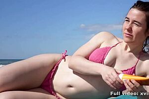 What’s happening when a boy reads but she acts on the beach?