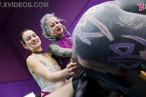 Heavy tattooed sub pegged by two dominas