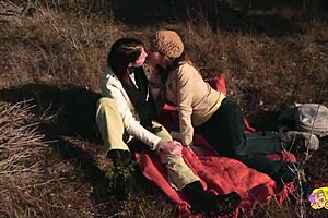 A couple of big-titted brunettes engage in wild lesbian sex with strapon, licking, and face sitting during an outdoor hike