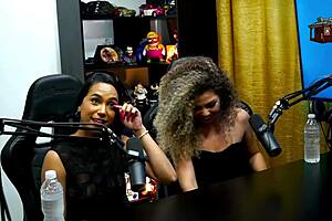 During the podcast, the latinas kissed passionately, leaving the host speechless.