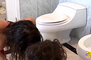 these two lesbians are getting rough in the toilet with fisting and fingering their asses