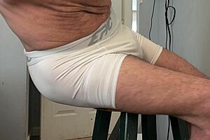 Bodybuilder Stretches Groin in Tight Spandex Shorts on Desk