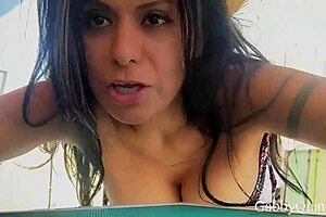 Brunette Beauty Teasingly Shows Off Natural Tits in Sensual Glamour.