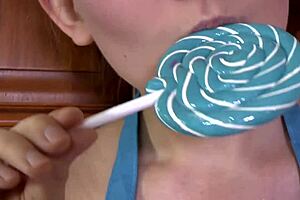 Brunette enjoys sucking a lollipop in high heels