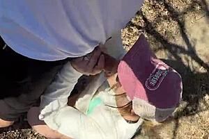 Milf couple caught in forest doggystyle with monster cock and big tits exposed.